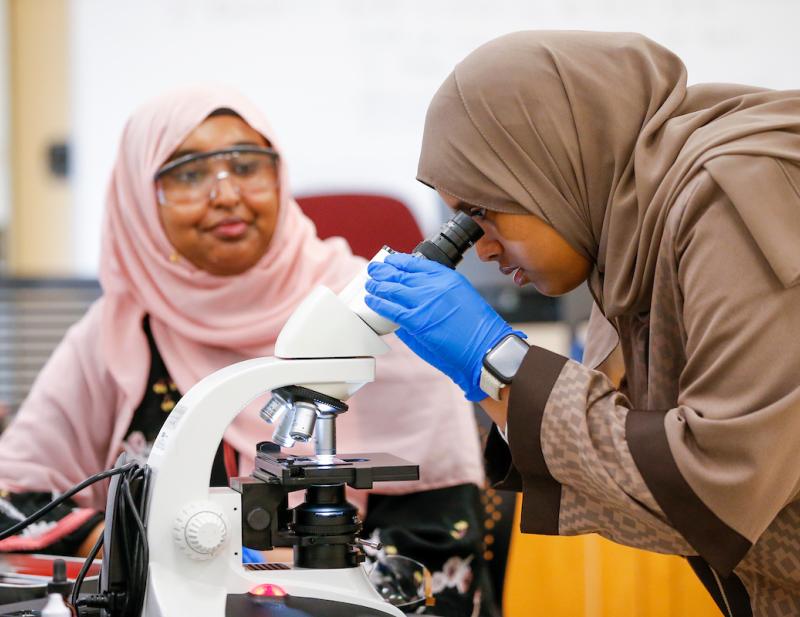 Two women in hijabs working in a lab